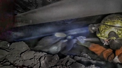 Shovelling coal onto the conveyer belt