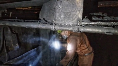 Coal dropping from the conveyer belt into tubs.